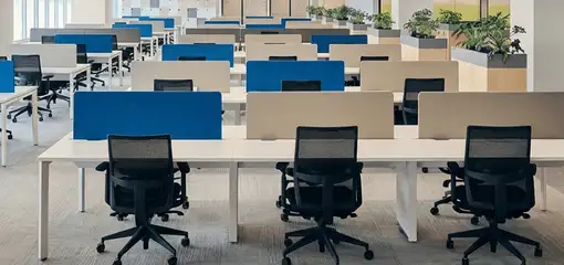 Modern open-plan office space featuring clean workstations, ergonomic chairs, and sanitized carpets provided by professional office cleaning services in Birmingham, AL.