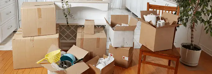 Packed moving boxes and household items in a kitchen before move-out or move-in cleaning, Birmingham, AL.
